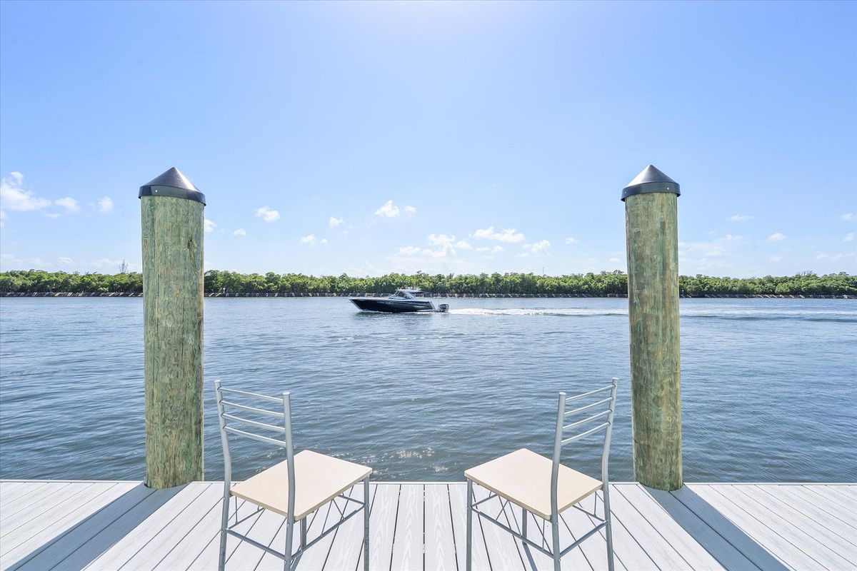 Two chairs at the end of the dock